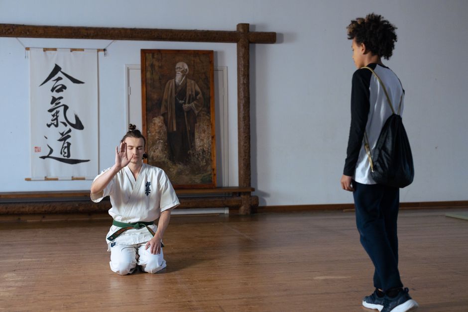 Martial arts student meditating before training